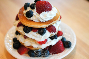 Whole wheat pancakes with whipped cream and berries