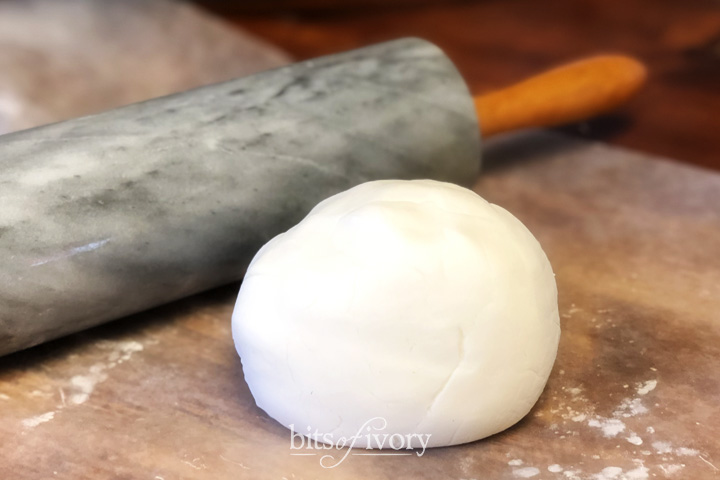 White ornament dough with rolling pin.